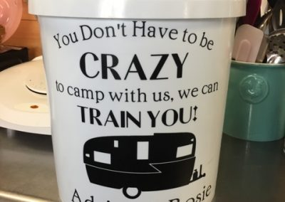 photo of a 5 gallon bucket that says you don't have to be crazy to camp with us, we can train you!