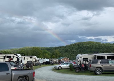 photo of rainbow over a full campground