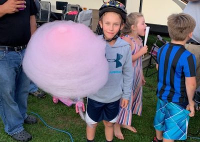photo of kid with large pink cotton candy